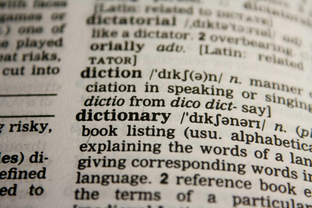 Detailed close-up view of a dictionary page highlighting the word 'dictionary' and its definition.