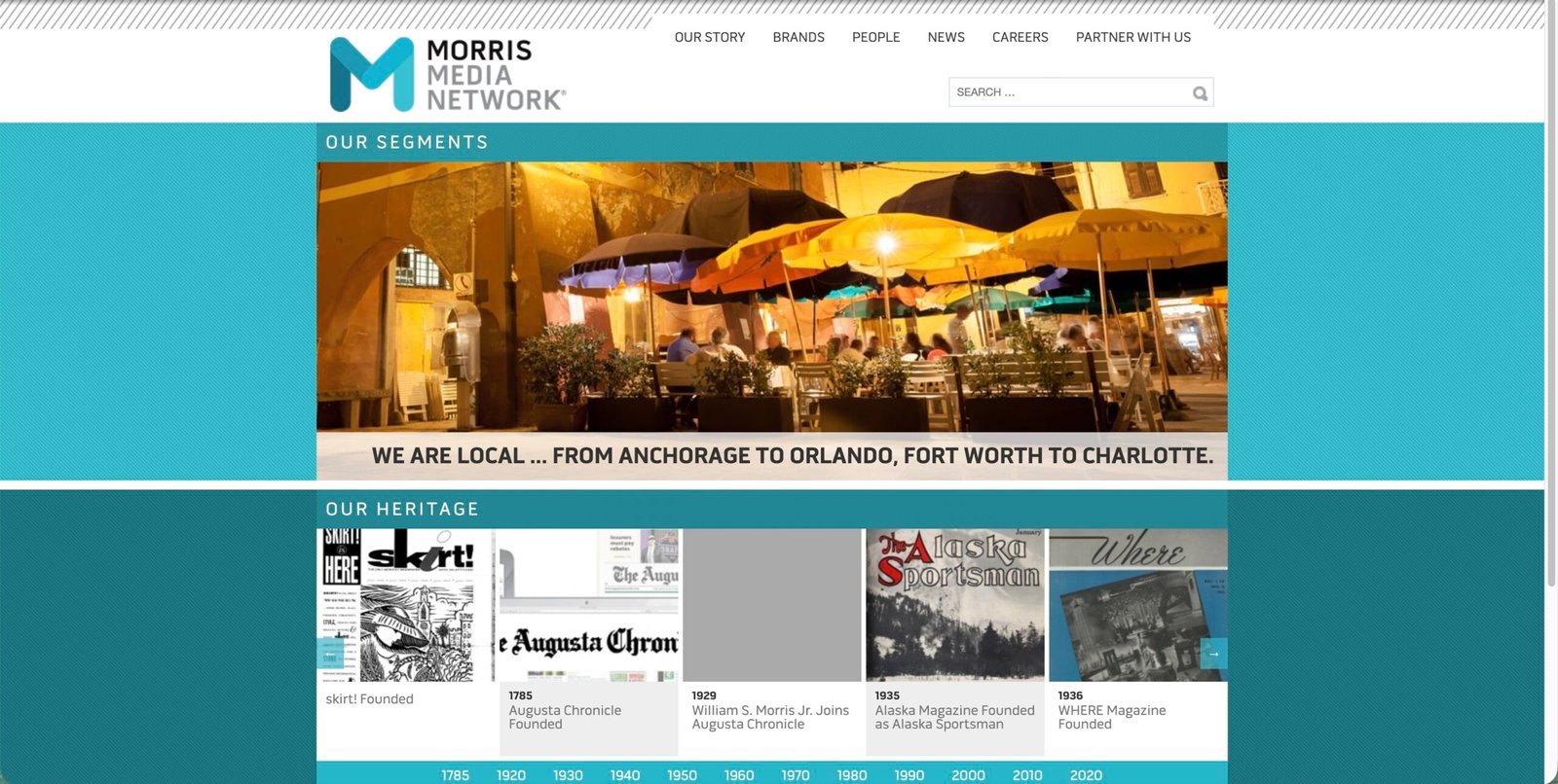 Person writing and researching at a laptop